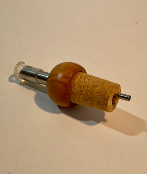 Cap with olive wood dispenser