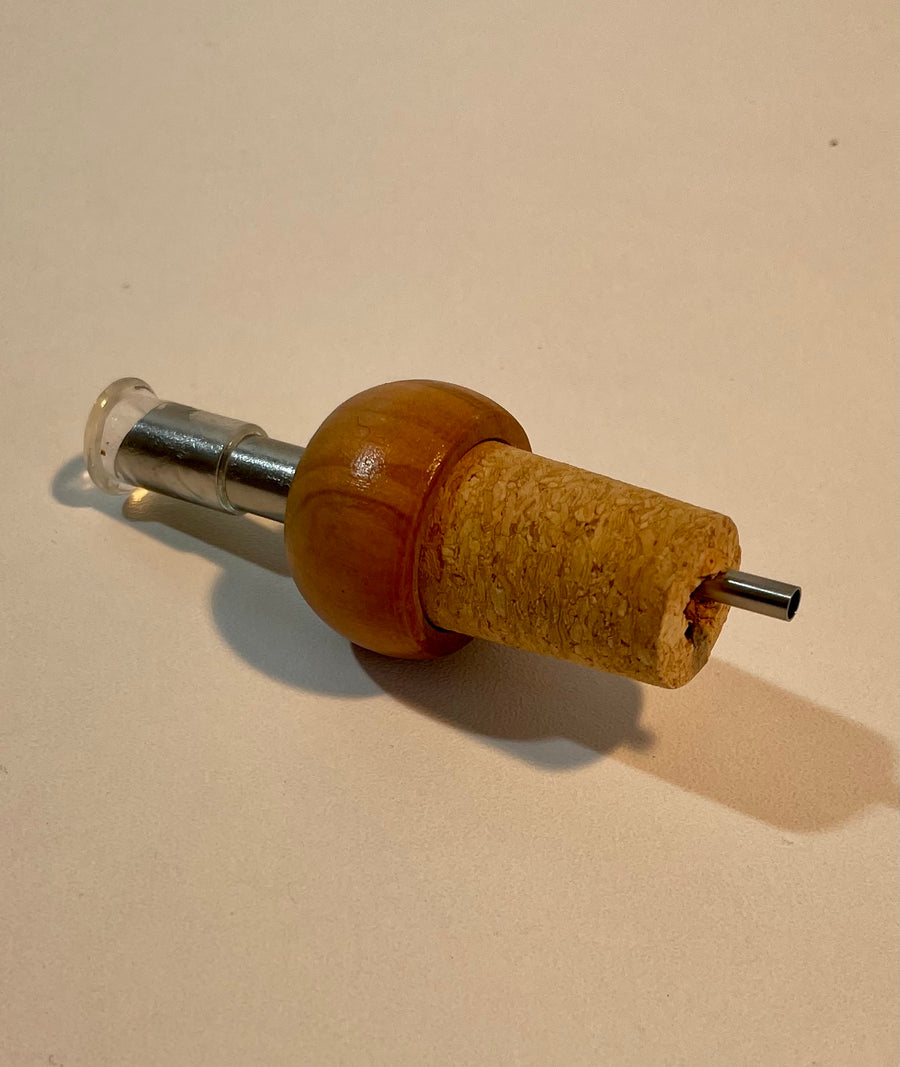 Cap with olive wood dispenser